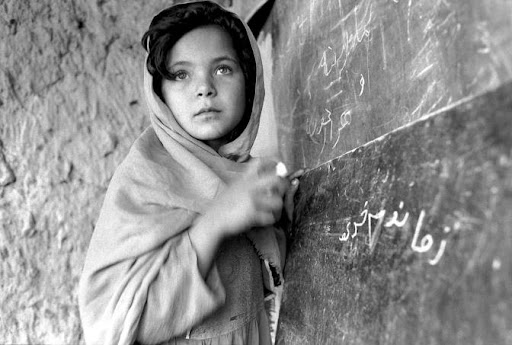 Young Afghan girl attends school