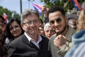 Taha Bouhafs aux côtés de Jean-Luc Mélenchon lors du 1er mai