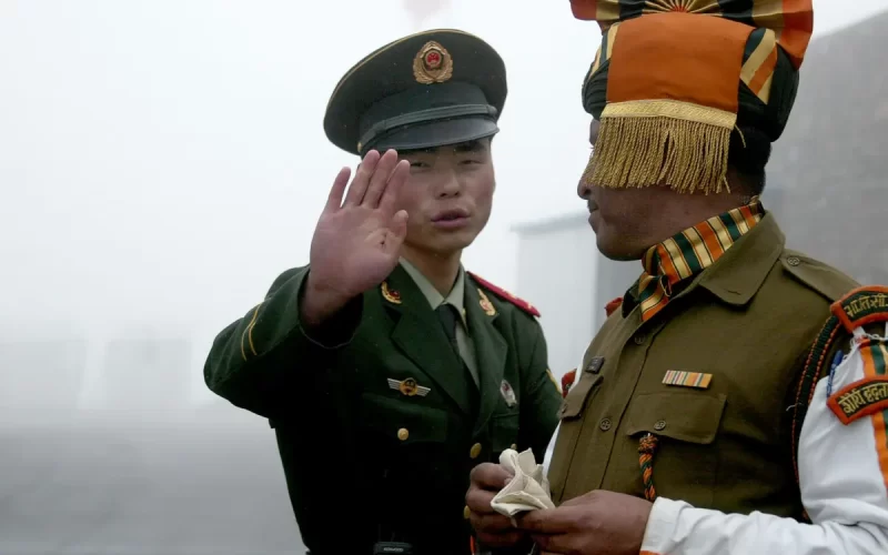 A Chinese and an Indian soldier at the Nathu La border crossing in India’s north-eastern Sikkim state in 2008. Photograph: Diptendu Dutta/AFP/Getty Images